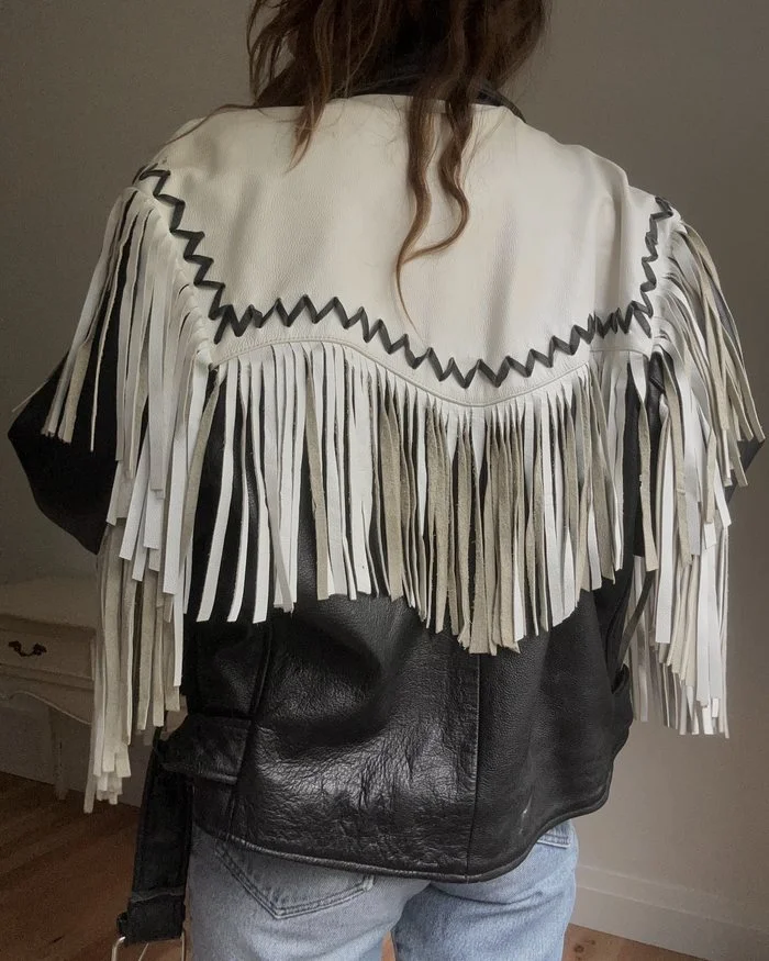 Back of a vintage black and white leather fringe jacket